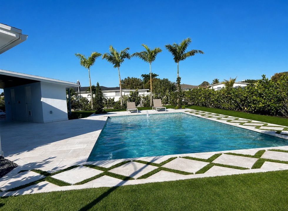 Bright pool and patio with palm trees