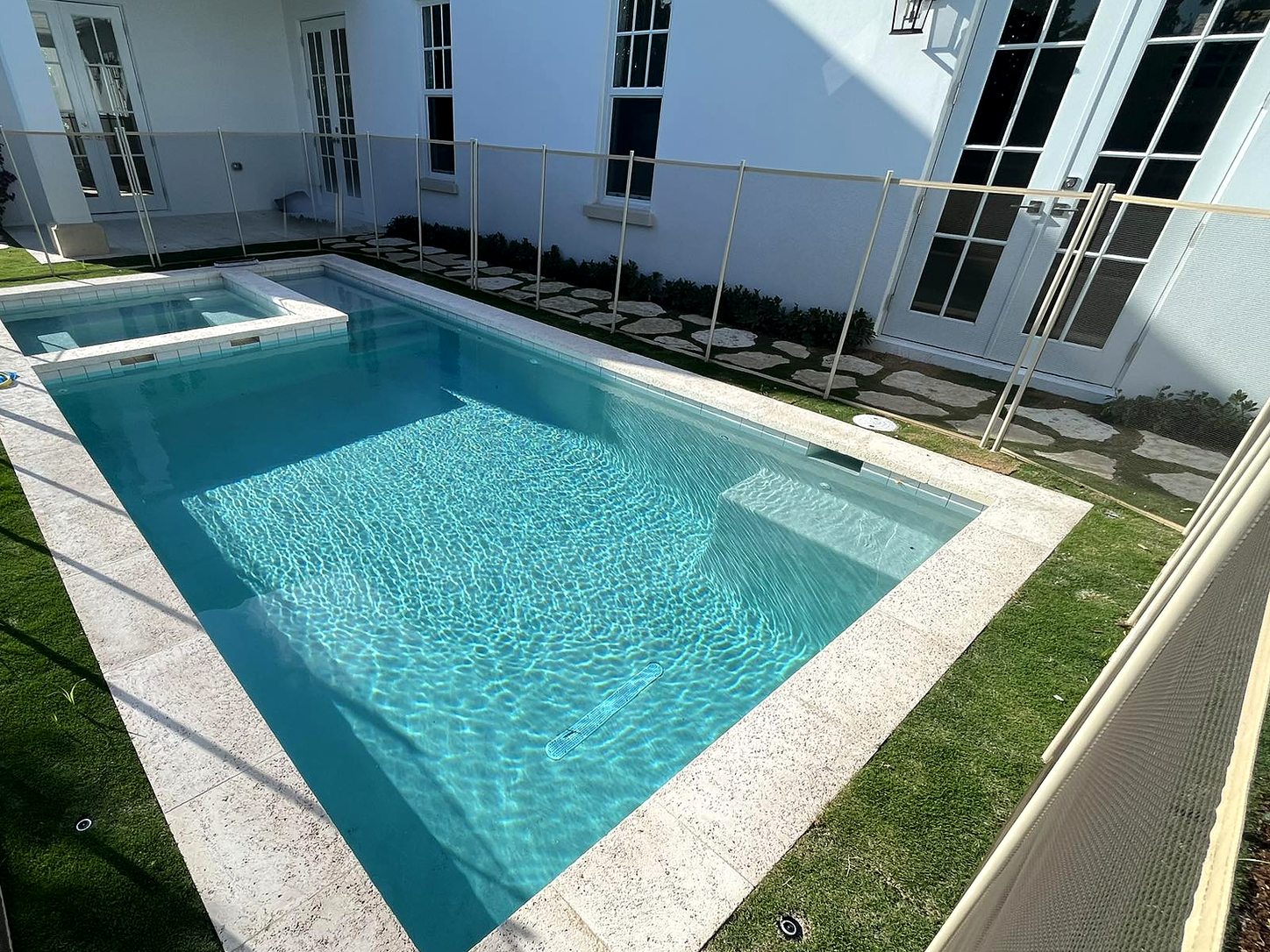 Pool with waterfall feature and screened patio